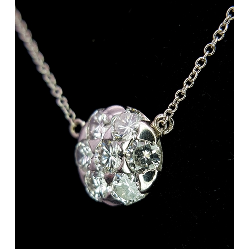 90 - An 18K White Gold and Diamond Circular Lavaliere Pendant on an 18K White Gold Chain. c 1.2ctw of rou... 