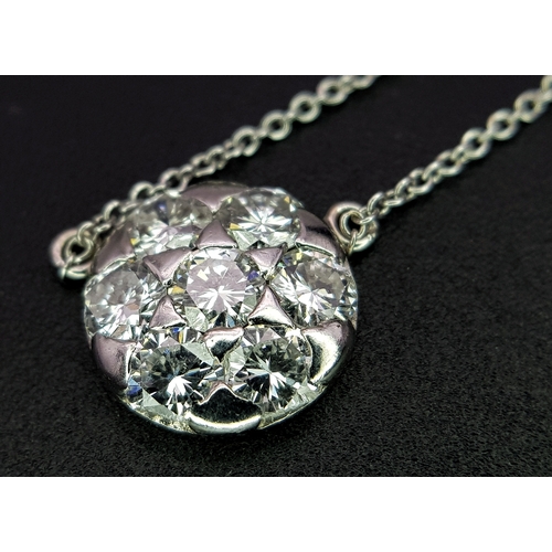 90 - An 18K White Gold and Diamond Circular Lavaliere Pendant on an 18K White Gold Chain. c 1.2ctw of rou... 