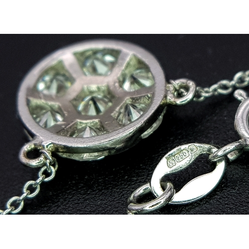 90 - An 18K White Gold and Diamond Circular Lavaliere Pendant on an 18K White Gold Chain. c 1.2ctw of rou... 