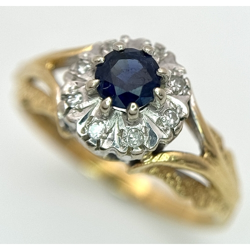 67 - An 18K Yellow Gold Sapphire and Diamond Ring. Oval cut sapphire with a classic diamond halo. Size N.... 