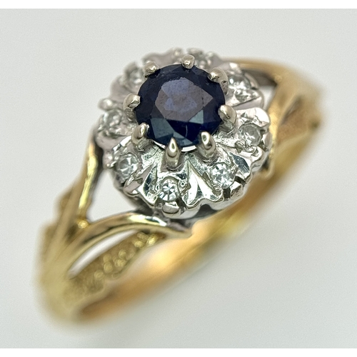 67 - An 18K Yellow Gold Sapphire and Diamond Ring. Oval cut sapphire with a classic diamond halo. Size N.... 