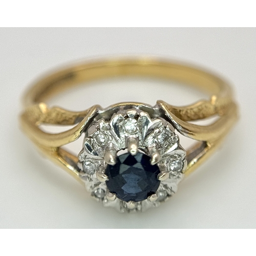 67 - An 18K Yellow Gold Sapphire and Diamond Ring. Oval cut sapphire with a classic diamond halo. Size N.... 