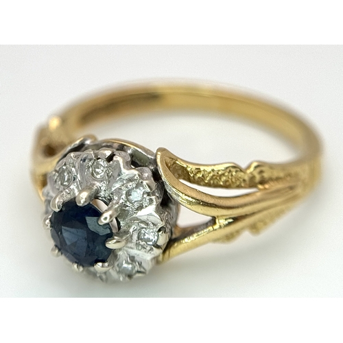 67 - An 18K Yellow Gold Sapphire and Diamond Ring. Oval cut sapphire with a classic diamond halo. Size N.... 