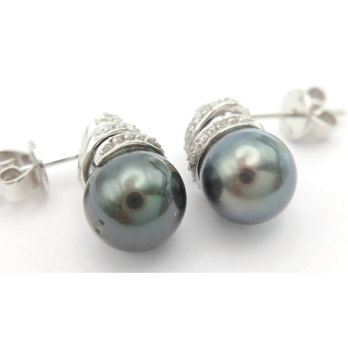 73 - A PAIR OF 18K WHITE GOLD, DIAMOND AND PEARL, SPIRAL DESIGN, DROP EARRINGS. 4G. MS RED 1011