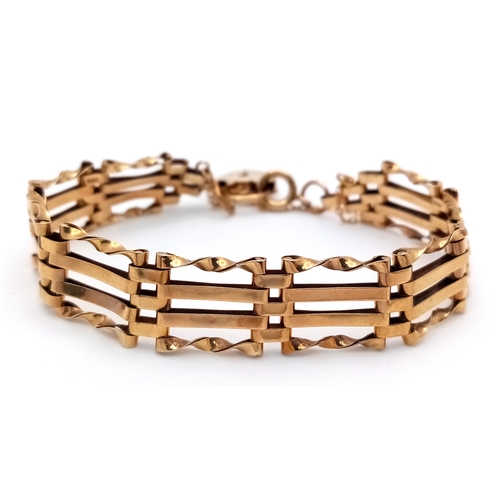 74 - A 9K Yellow Gold Gate Link Bracelet with Heart Clasp. 13mm width. 18cm length. 9.82g.