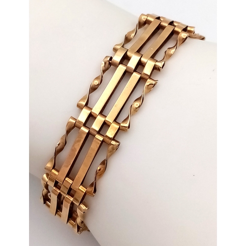 74 - A 9K Yellow Gold Gate Link Bracelet with Heart Clasp. 13mm width. 18cm length. 9.82g.