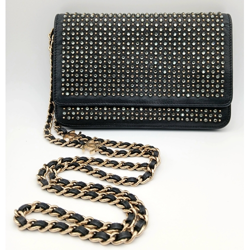 78 - A Chanel Studded Leather Wallet on Chain / Clutch. Crafted from black grained leather, the exterior ... 