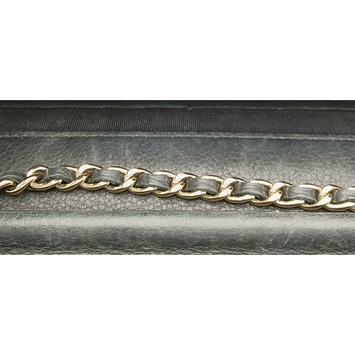 78 - A Chanel Studded Leather Wallet on Chain / Clutch. Crafted from black grained leather, the exterior ... 