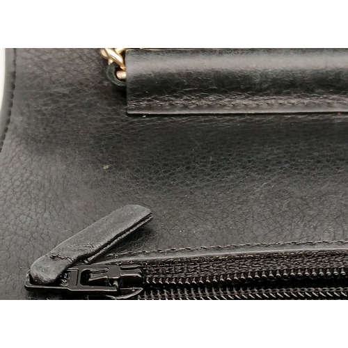 78 - A Chanel Studded Leather Wallet on Chain / Clutch. Crafted from black grained leather, the exterior ... 