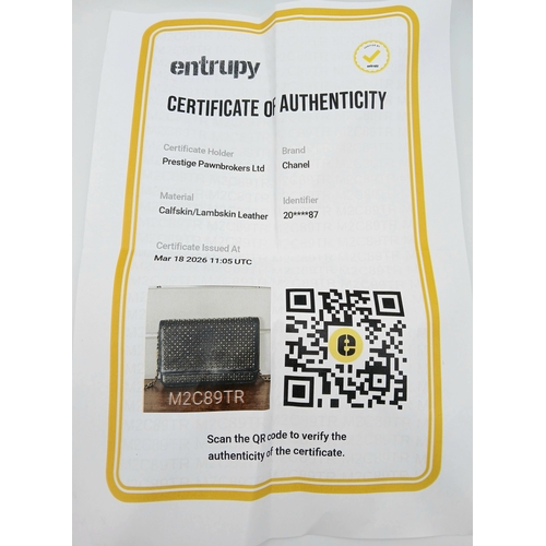 78 - A Chanel Studded Leather Wallet on Chain / Clutch. Crafted from black grained leather, the exterior ... 