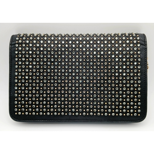 78 - A Chanel Studded Leather Wallet on Chain / Clutch. Crafted from black grained leather, the exterior ... 
