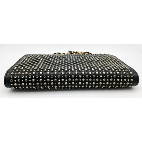 78 - A Chanel Studded Leather Wallet on Chain / Clutch. Crafted from black grained leather, the exterior ... 