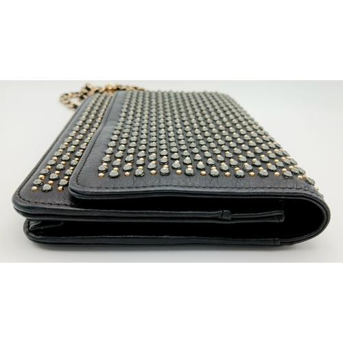 78 - A Chanel Studded Leather Wallet on Chain / Clutch. Crafted from black grained leather, the exterior ... 