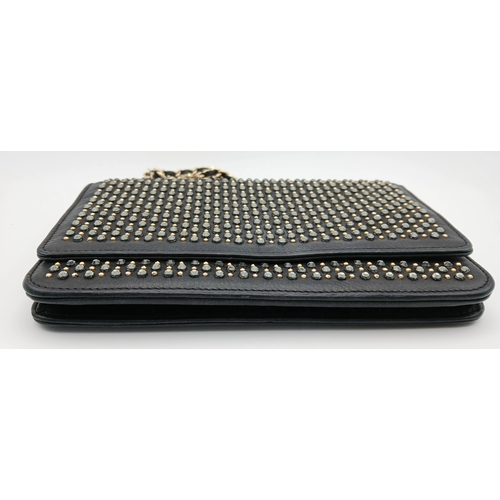 78 - A Chanel Studded Leather Wallet on Chain / Clutch. Crafted from black grained leather, the exterior ... 
