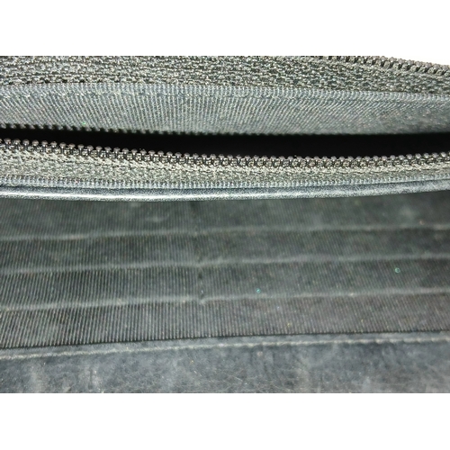 78 - A Chanel Studded Leather Wallet on Chain / Clutch. Crafted from black grained leather, the exterior ... 