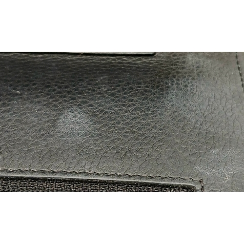 78 - A Chanel Studded Leather Wallet on Chain / Clutch. Crafted from black grained leather, the exterior ... 