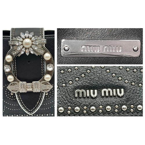 99 - A Miu Miu Black Embellished Handbag. Leather exterior with white stone, faux pearl and stud embellis... 