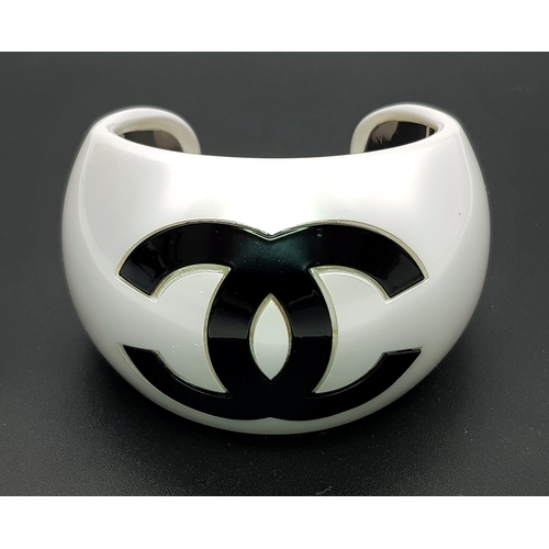 104 - A Chanel Limited Edition Black and Pearl Resin CC Cuff Bracelet. 5cm width at its widest. 57mm inner... 