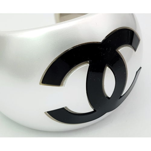 104 - A Chanel Limited Edition Black and Pearl Resin CC Cuff Bracelet. 5cm width at its widest. 57mm inner... 