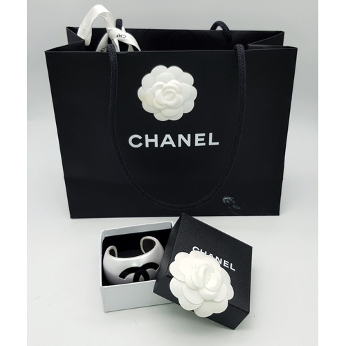 104 - A Chanel Limited Edition Black and Pearl Resin CC Cuff Bracelet. 5cm width at its widest. 57mm inner... 