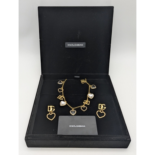 111 - A Dolce & Gabbana Logo and Hearts Necklace and Earrings Set. From the Italian Tailoring Collection. ... 