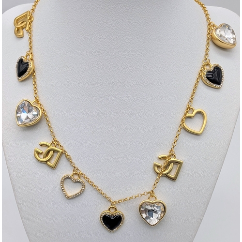 111 - A Dolce & Gabbana Logo and Hearts Necklace and Earrings Set. From the Italian Tailoring Collection. ... 