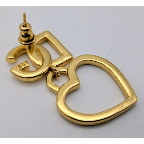 111 - A Dolce & Gabbana Logo and Hearts Necklace and Earrings Set. From the Italian Tailoring Collection. ... 