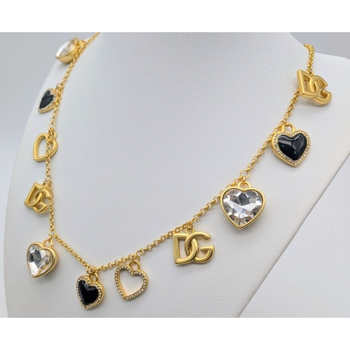 111 - A Dolce & Gabbana Logo and Hearts Necklace and Earrings Set. From the Italian Tailoring Collection. ... 