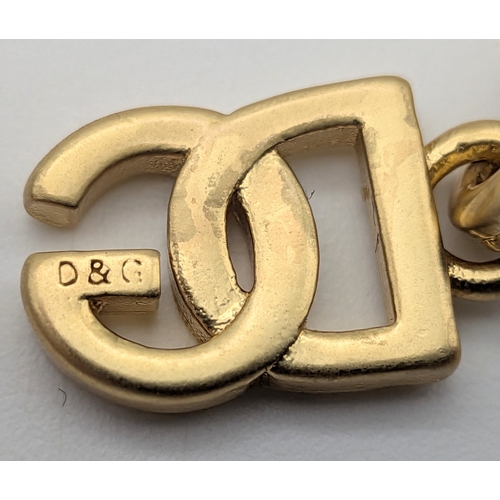 111 - A Dolce & Gabbana Logo and Hearts Necklace and Earrings Set. From the Italian Tailoring Collection. ... 