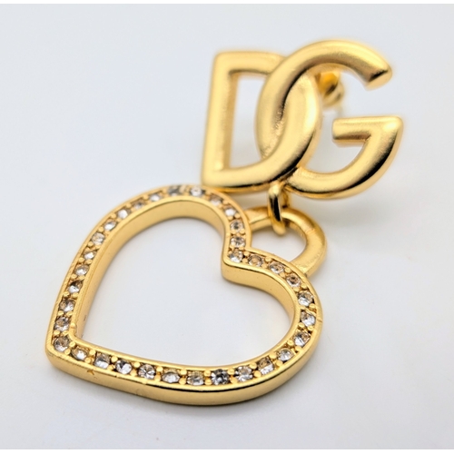 111 - A Dolce & Gabbana Logo and Hearts Necklace and Earrings Set. From the Italian Tailoring Collection. ... 