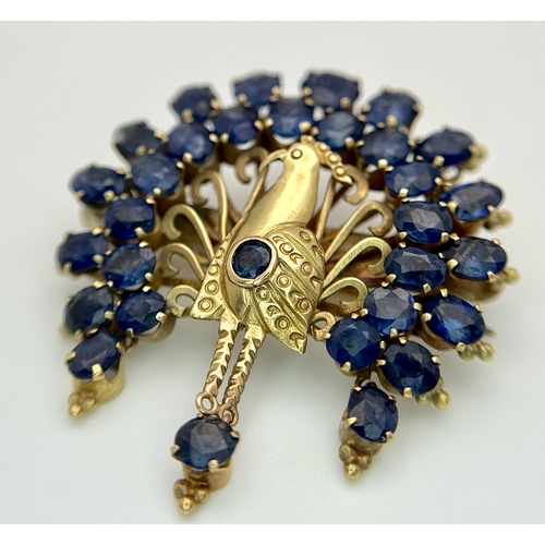 198 - A 14K Yellow Gold Sapphire Peacock Brooch. White metal backing. One stone missing. 30mm x 34mm. 5.19... 