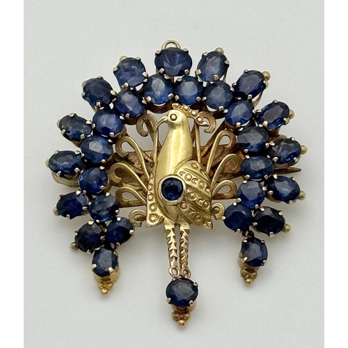 198 - A 14K Yellow Gold Sapphire Peacock Brooch. White metal backing. One stone missing. 30mm x 34mm. 5.19... 