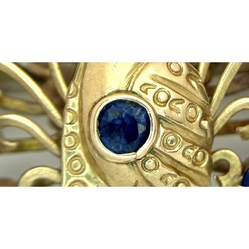 198 - A 14K Yellow Gold Sapphire Peacock Brooch. White metal backing. One stone missing. 30mm x 34mm. 5.19... 