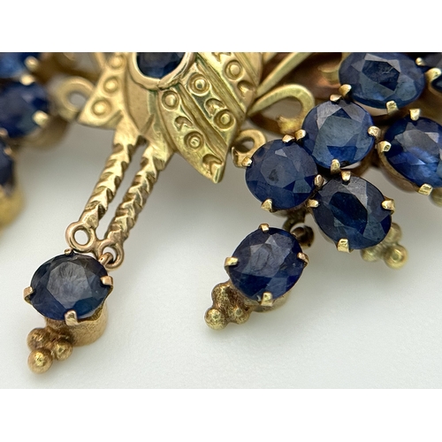 198 - A 14K Yellow Gold Sapphire Peacock Brooch. White metal backing. One stone missing. 30mm x 34mm. 5.19... 