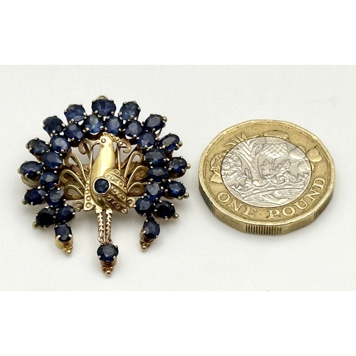 198 - A 14K Yellow Gold Sapphire Peacock Brooch. White metal backing. One stone missing. 30mm x 34mm. 5.19... 