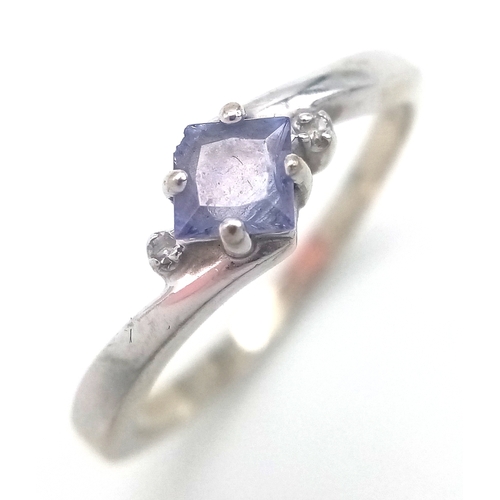 210 - 14 CARAT WHITE GOLD and TANZANITE RING. 2.26 Grams. Size N.