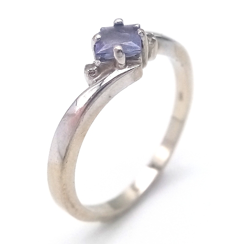 210 - 14 CARAT WHITE GOLD and TANZANITE RING. 2.26 Grams. Size N.