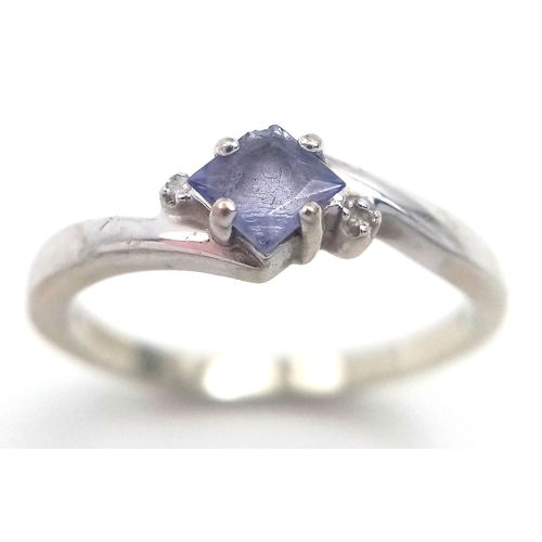 210 - 14 CARAT WHITE GOLD and TANZANITE RING. 2.26 Grams. Size N.