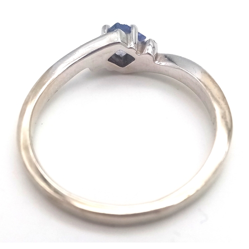 210 - 14 CARAT WHITE GOLD and TANZANITE RING. 2.26 Grams. Size N.
