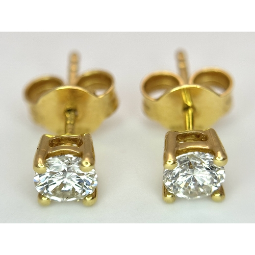 212 - A Pair of 18K Yellow Gold Diamond Stud Earrings. 0.70ctw of round brilliant cuts having near white c... 