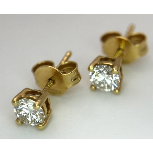 212 - A Pair of 18K Yellow Gold Diamond Stud Earrings. 0.70ctw of round brilliant cuts having near white c... 