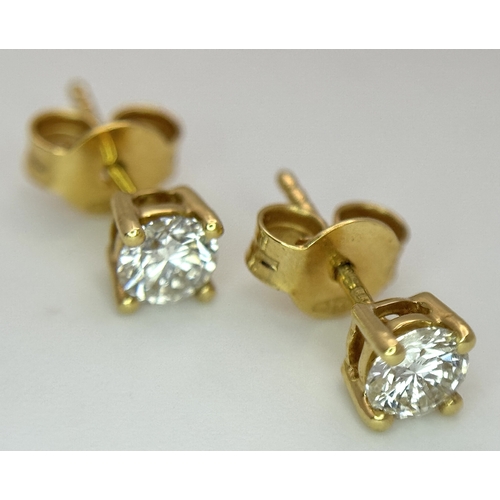 212 - A Pair of 18K Yellow Gold Diamond Stud Earrings. 0.70ctw of round brilliant cuts having near white c... 