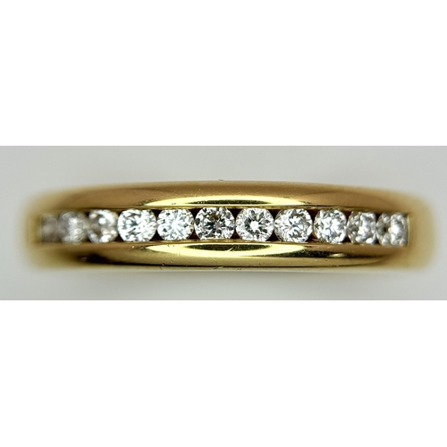 219 - An 18K Yellow Gold and Diamond Half Eternity Ring. Size N. Channel set round brilliant cut diamonds.... 