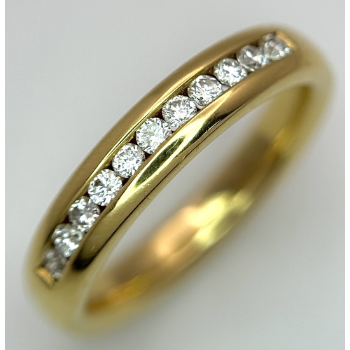 219 - An 18K Yellow Gold and Diamond Half Eternity Ring. Size N. Channel set round brilliant cut diamonds.... 