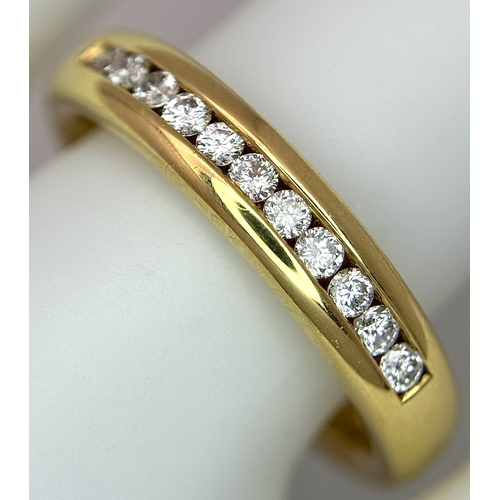 219 - An 18K Yellow Gold and Diamond Half Eternity Ring. Size N. Channel set round brilliant cut diamonds.... 