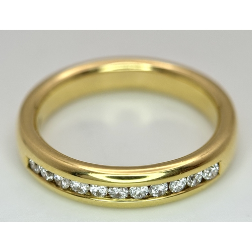 219 - An 18K Yellow Gold and Diamond Half Eternity Ring. Size N. Channel set round brilliant cut diamonds.... 