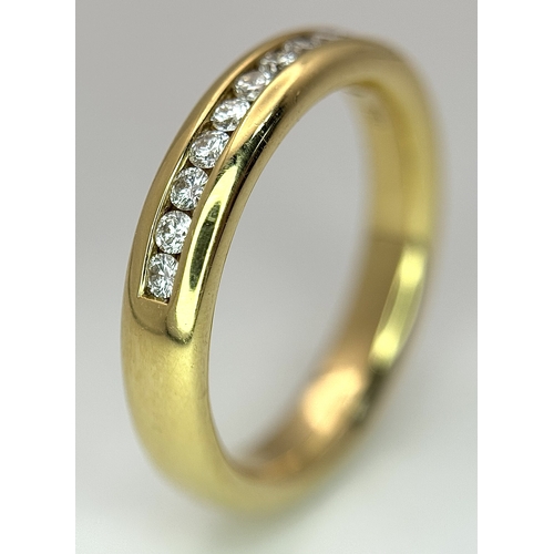 219 - An 18K Yellow Gold and Diamond Half Eternity Ring. Size N. Channel set round brilliant cut diamonds.... 