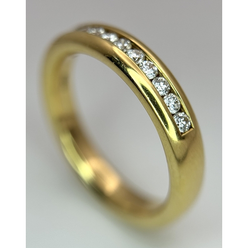 219 - An 18K Yellow Gold and Diamond Half Eternity Ring. Size N. Channel set round brilliant cut diamonds.... 