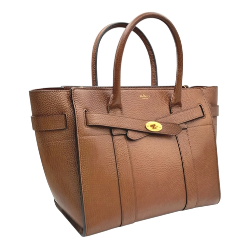 225 - A Mulberry Bayswater Handbag. Oak brown grain leather exterior with gold-toned hardware, dual top ha... 