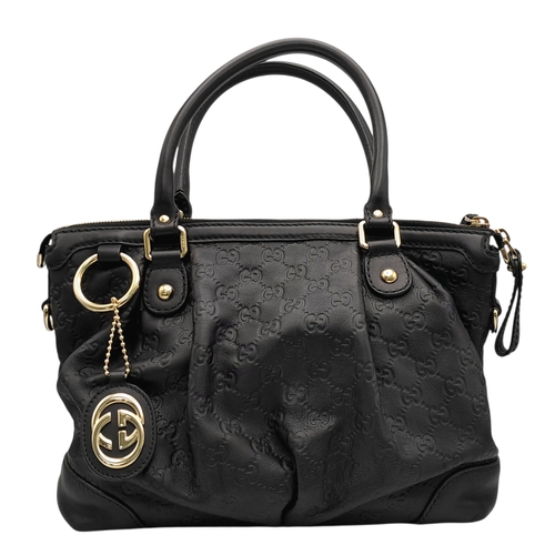 232 - A Gucci Guccissima Sukey Handbag. Black GG monogram embossed leather exterior with silver-tone hardw... 